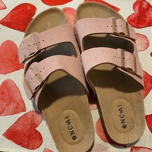 Never worn sandals. Slight scuff on left shoe from sitting on the shoe rack.